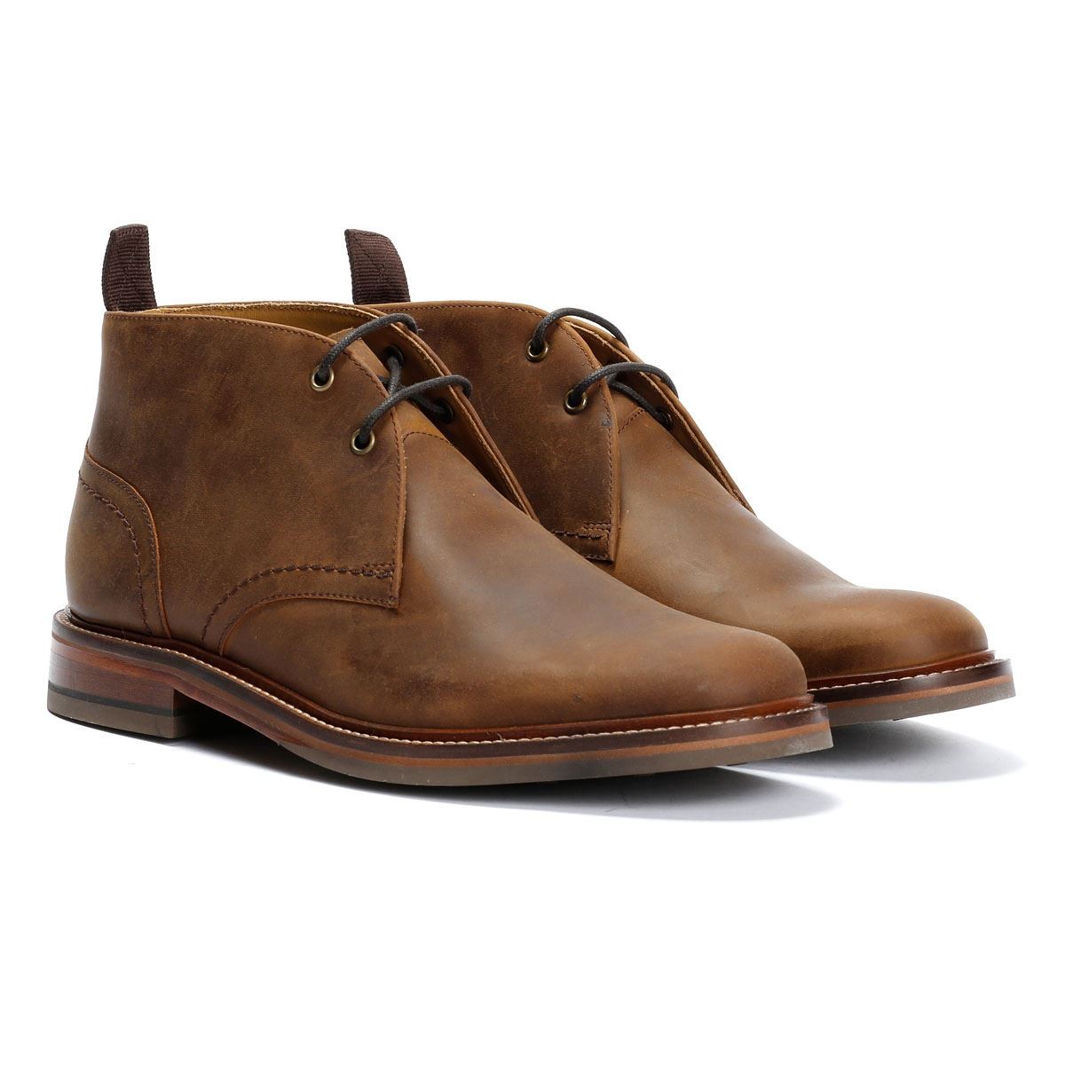 Brown leather chukka boots with a smooth finish, featuring a rounded toe, lace-up front, and a low stacked heel, designed for a stylish yet casual look.