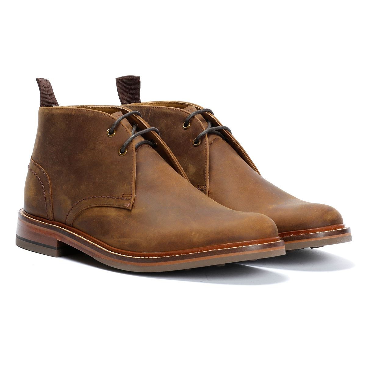 Tan oiled leather men's chukka boots featuring a classic design, lace-up front, and a sturdy sole, ideal for casual or semi-formal wear.