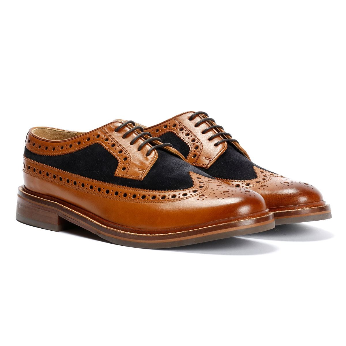 Tan leather and navy suede longwing brogue shoes featuring intricate perforations, lace-up design, and a stacked heel, ideal for formal or smart-casual occasions.