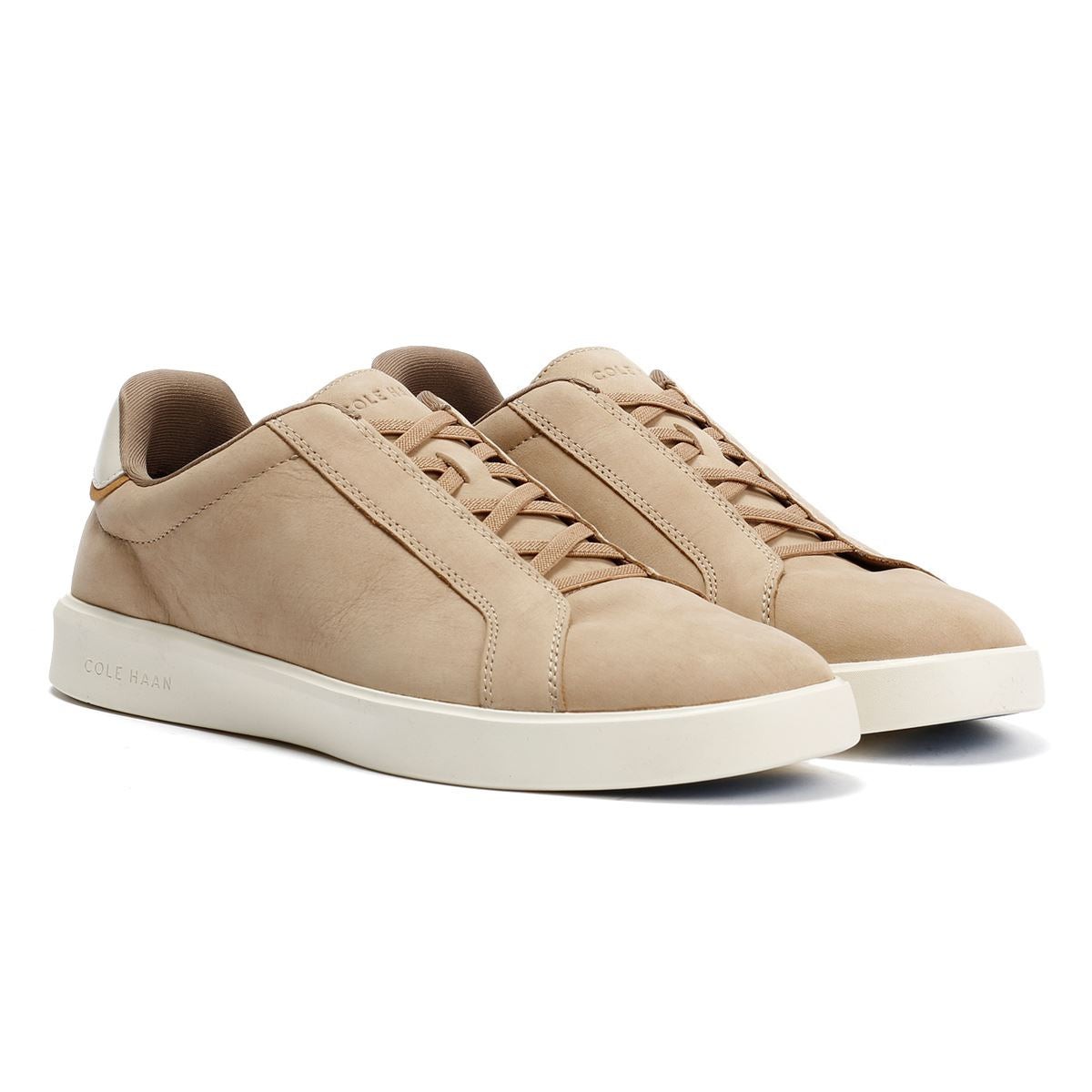 Light beige leather slip-on sneakers with a minimalist design, featuring a smooth finish, subtle stitching details, and a white rubber sole.