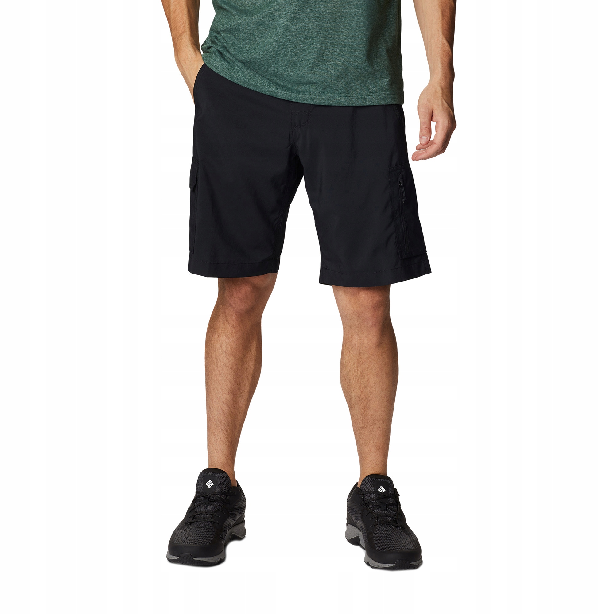 Black knee-length cargo shorts made of polyester, featuring multiple pockets, a relaxed fit, and paired with a green shirt and black athletic shoes.