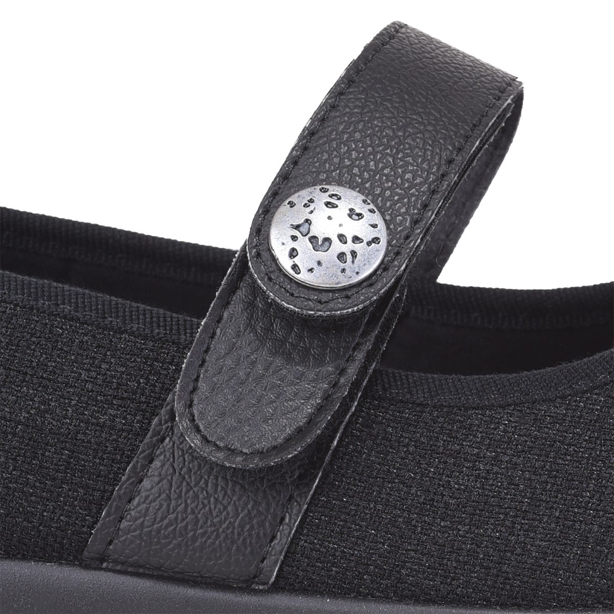 Black strap extension for shoes featuring a textured leather finish and a decorative silver button, designed for added comfort and adjustability.