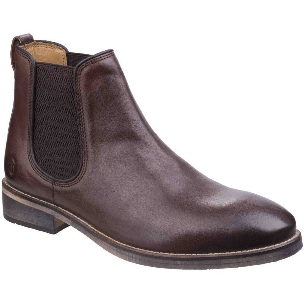 Dark brown leather Chelsea boot featuring elastic side panels, a sleek silhouette, and a low stacked heel for a stylish and comfortable fit.