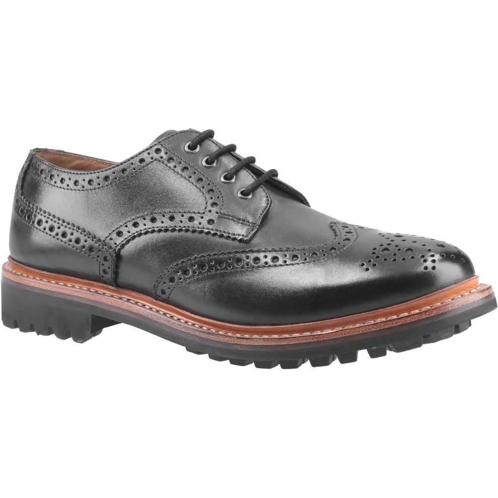 Black leather Goodyear welt shoe with brogue detailing, featuring a sturdy rubber sole and classic lace-up design, ideal for formal or casual wear.