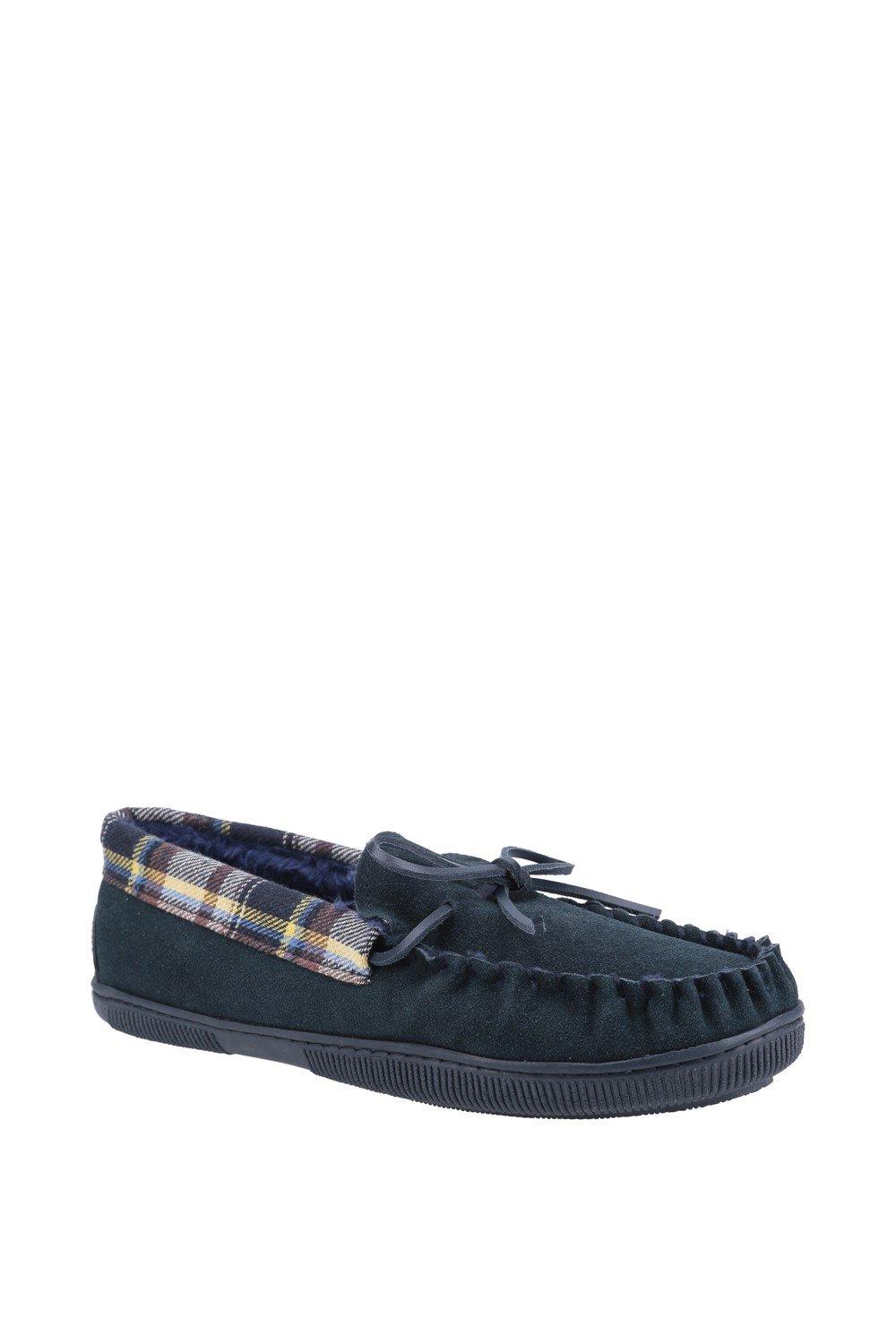Blue suede moccasin slipper featuring a plaid lining, decorative bow, and a textured rubber sole for grip and comfort.