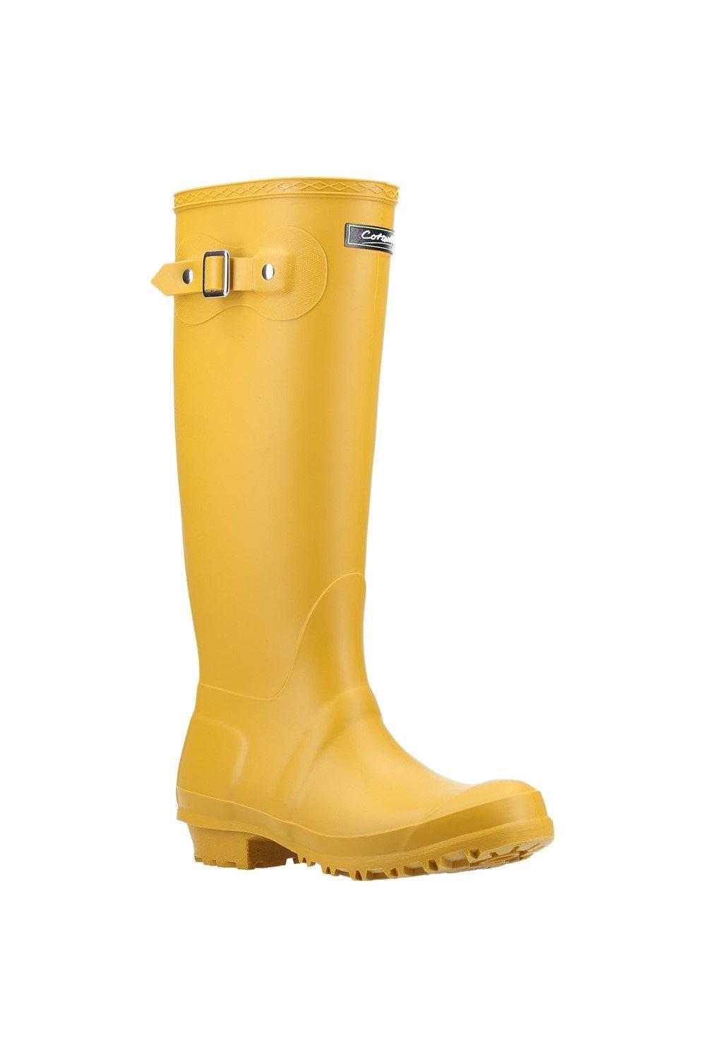 Bright yellow waterproof Wellington boots with a buckle detail and textured sole, designed for women, featuring a tall shaft for added coverage.