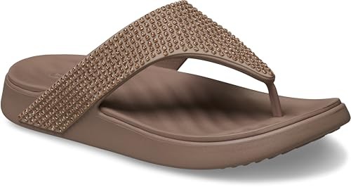 Brown flip-flop sandal featuring a textured footbed, a wide, embellished strap with rhinestones, and a lightweight, cushioned sole for comfort.