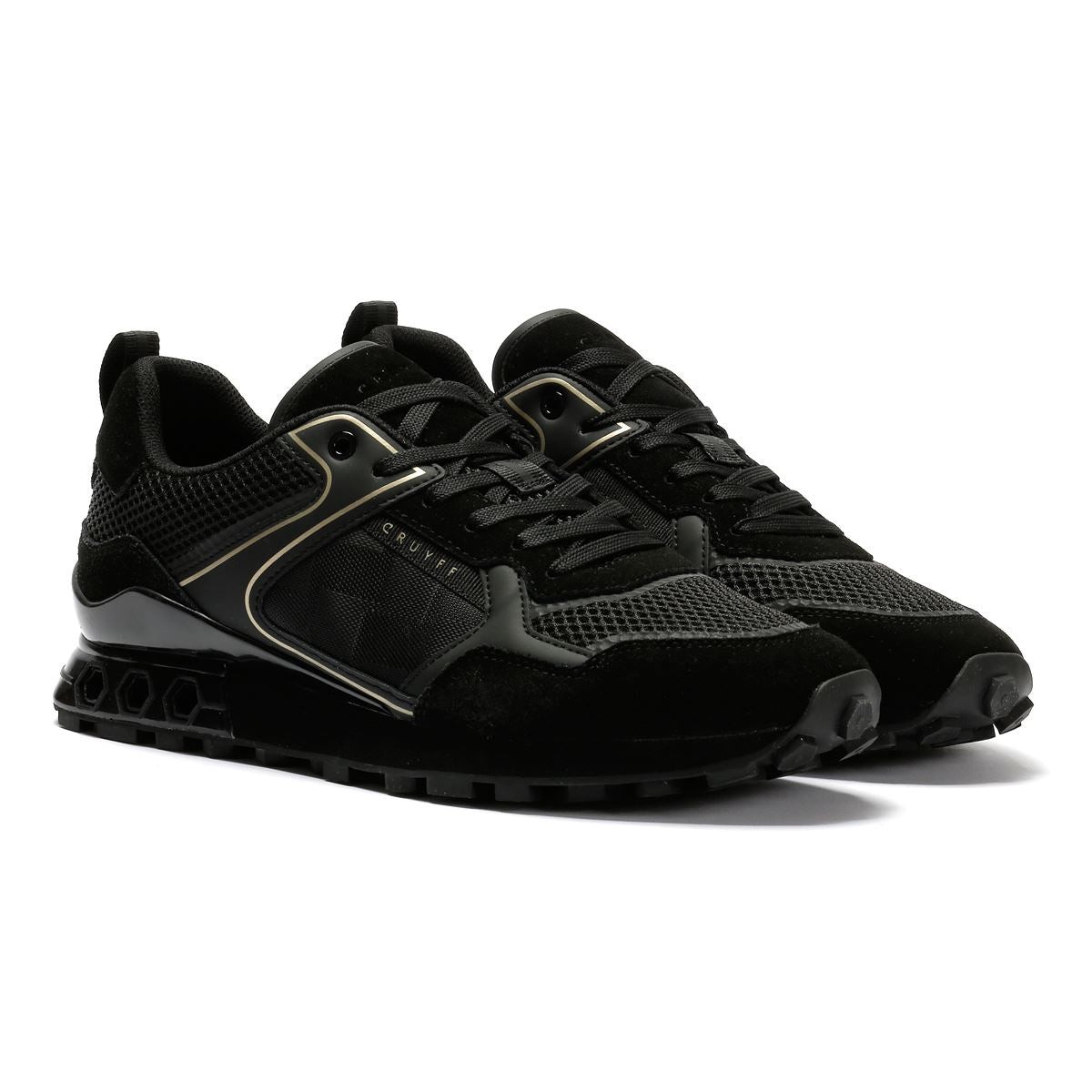 Black and gold trainers featuring a sleek design with suede and mesh materials, a cushioned sole, and a prominent Cruyff logo on the side.