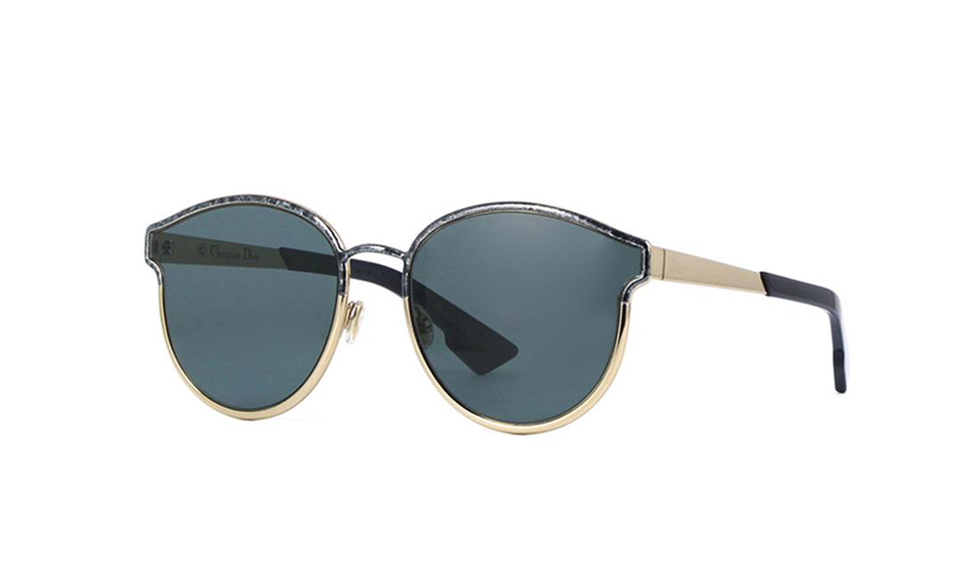Round sunglasses featuring a black and gold frame, with dark lenses and a unique asymmetric design, showcasing a stylish blend of materials.