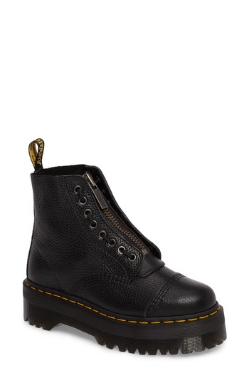 Black milled leather zip boots for kids by Dr. Martens, featuring a chunky sole, yellow stitching, and a side zipper for easy wear, size 5.