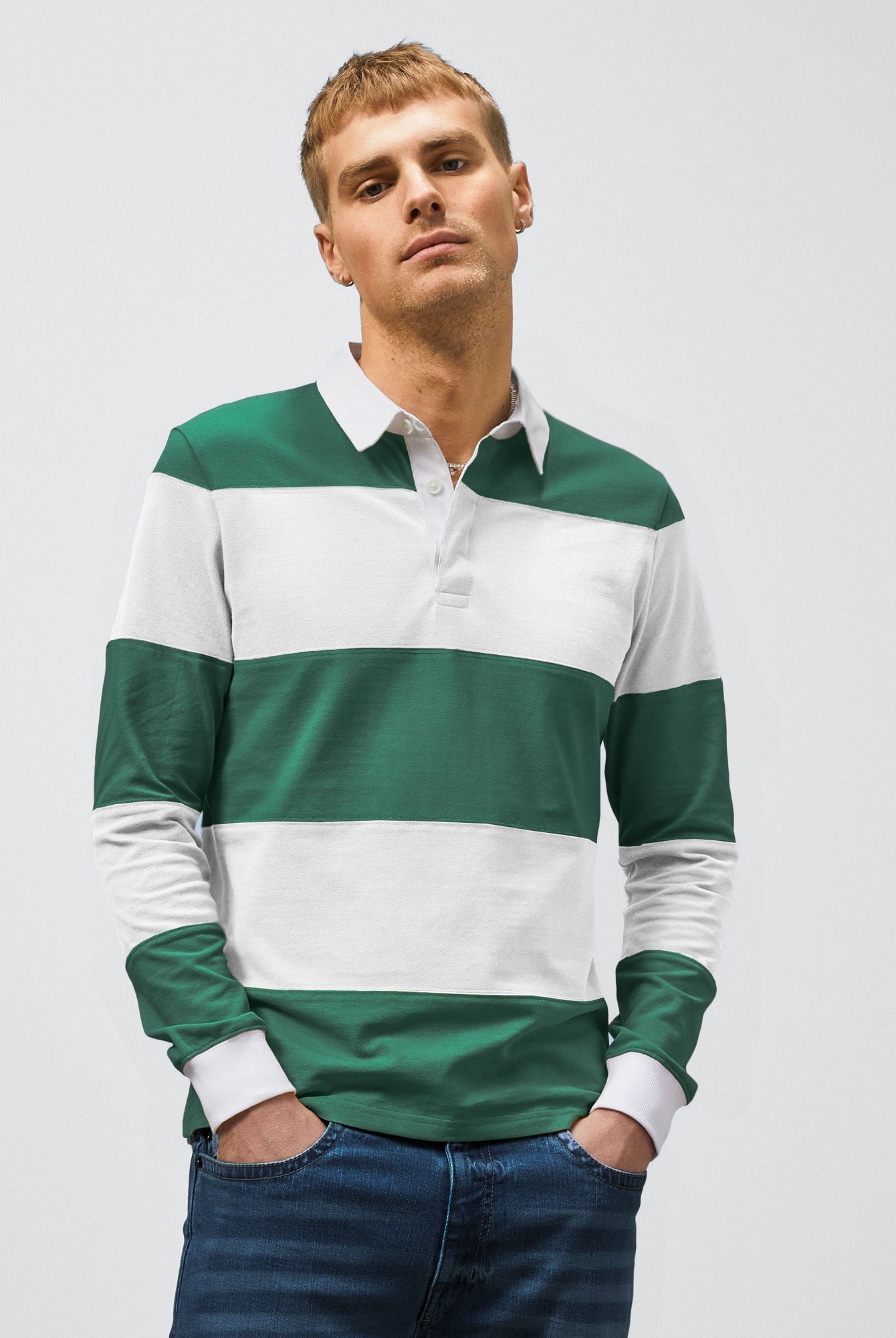 Green and white colour block long-sleeve polo shirt with a woven collar, featuring horizontal stripes and a relaxed fit, worn by a model.