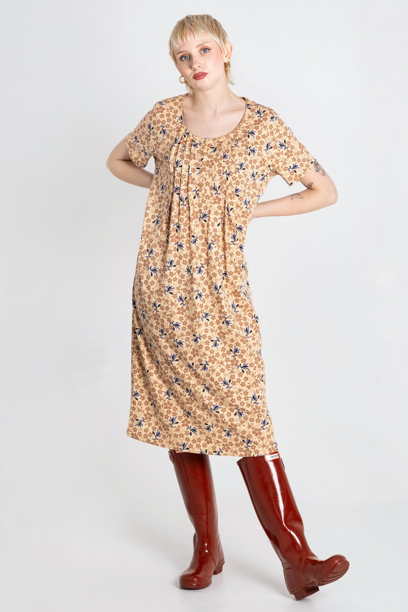 Beige short-sleeve nightdress with pleated details and floral print, designed for women in UK size 18, paired with glossy red knee-high boots.