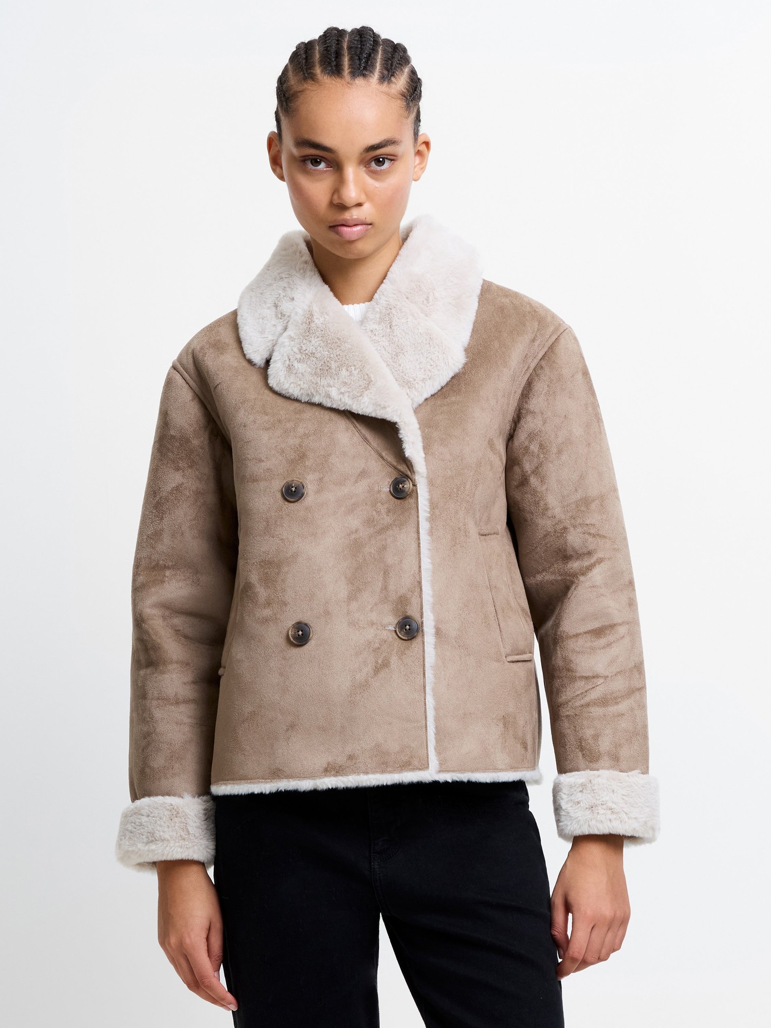 Faux suede double-breasted coat in taupe with a plush white fur collar and cuffs, featuring two dark buttons and side pockets, styled with a relaxed fit.