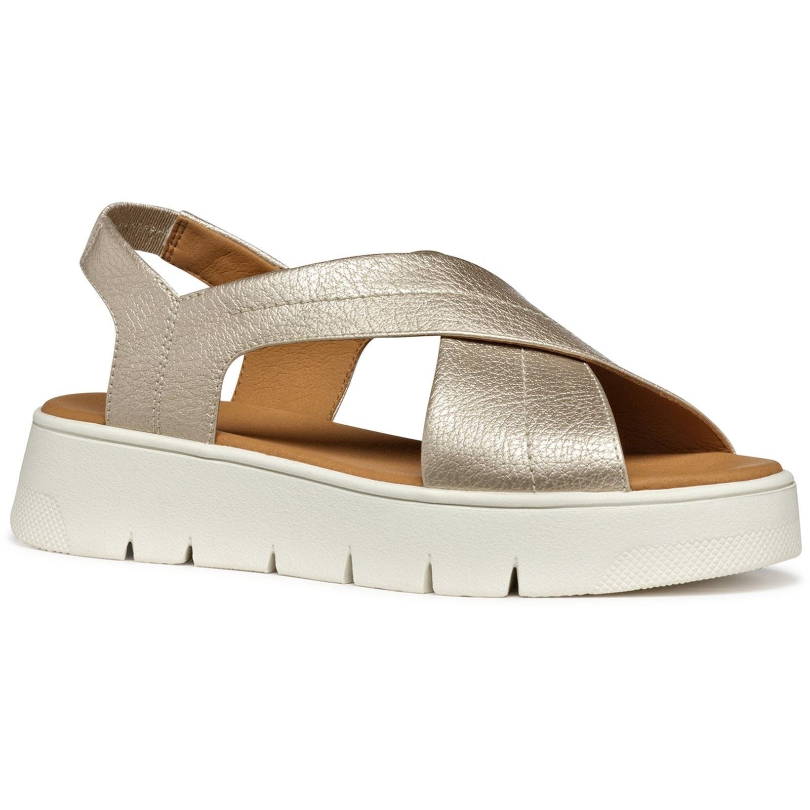 Light gold synthetic polyurethane women's sandals with a cross-strap design and a chunky white sole, featuring an open back for easy wear.
