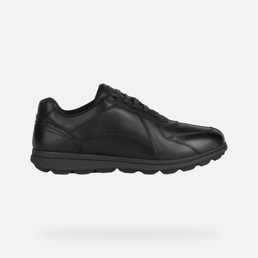 Black leather trainers with a sleek design, featuring a rounded toe, lace-up front, and a cushioned sole for comfort.