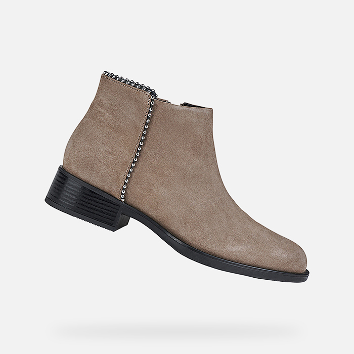 Beige leather ankle boots with a zip closure, featuring a decorative chain detail along the side and a low block heel, size 4 (UK).