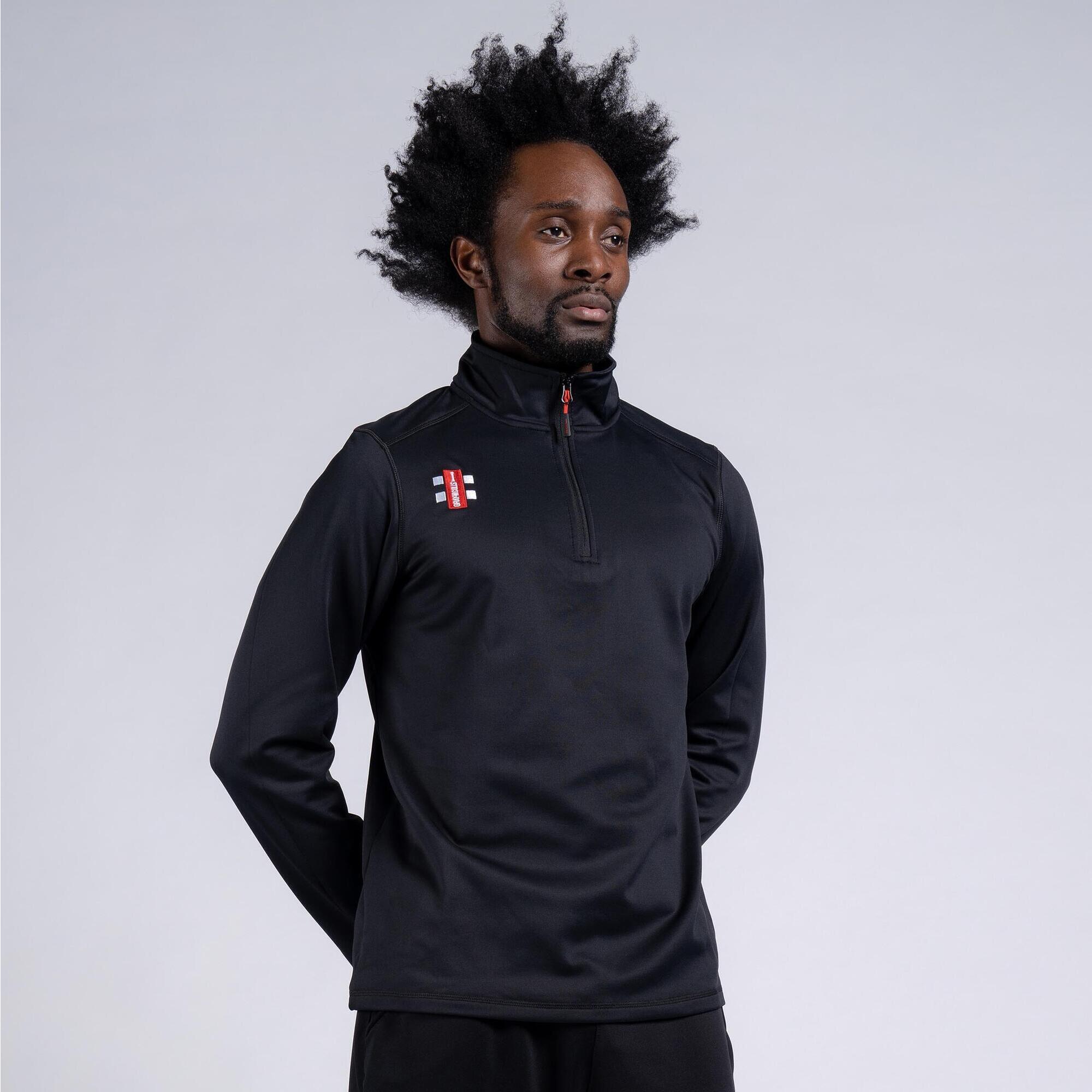 Black Gray-Nicolls Storm Fleece featuring a high collar, quarter-zip front, and logo detail on the chest, made from a soft, durable material ideal for outdoor activities.