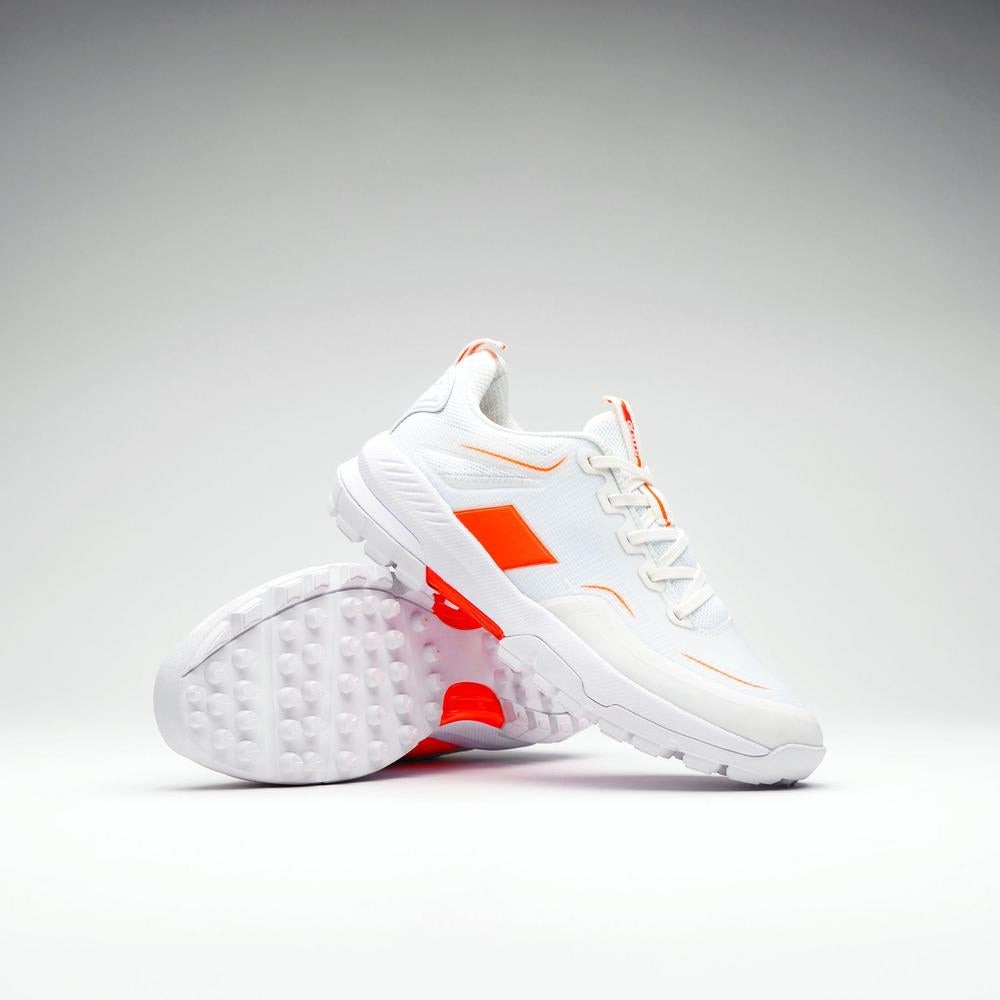 White Grays AeroCage X shoes featuring orange accents, a breathable upper, cushioned sole, and textured outsole for enhanced grip and performance.