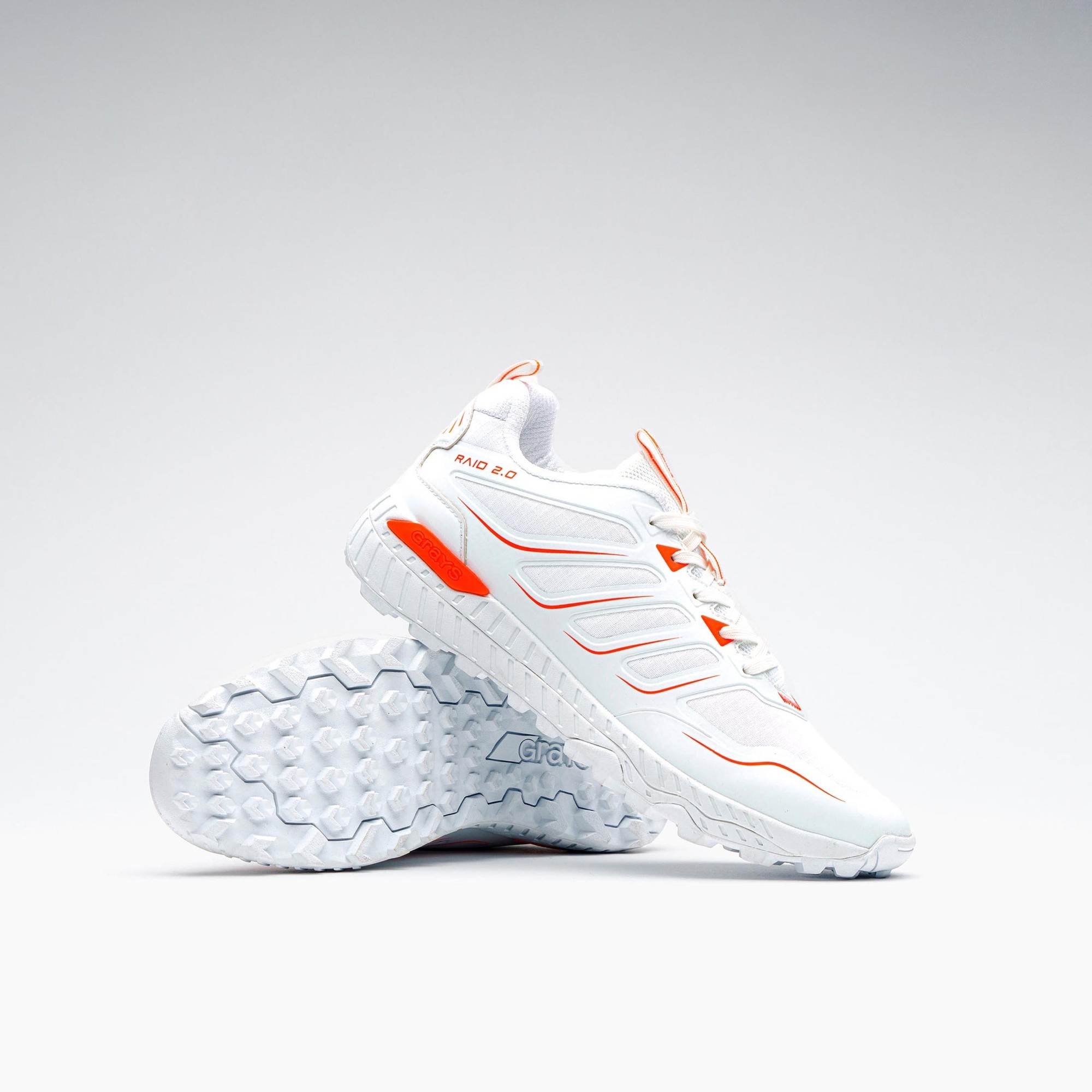 White Grays Raid 2.0 Junior Shoe featuring orange accents, a textured sole for grip, and a lightweight design, ideal for hockey performance.