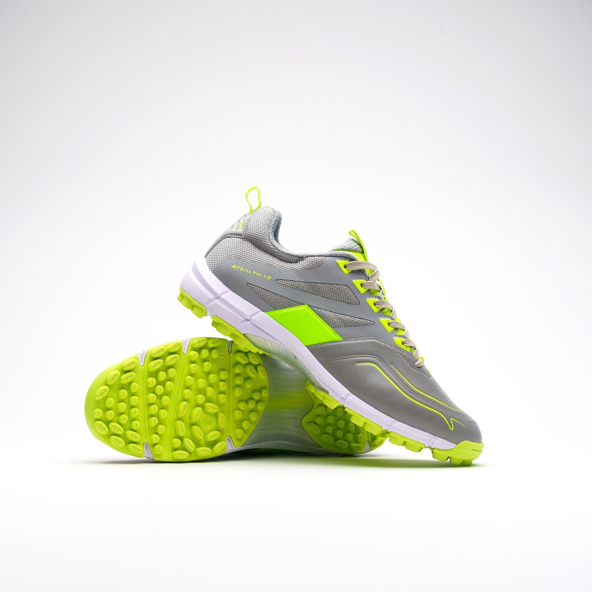 Grey and fluo yellow Grays Stealth Junior shoes with a lightweight design, featuring a textured sole for traction and reflective details for visibility.