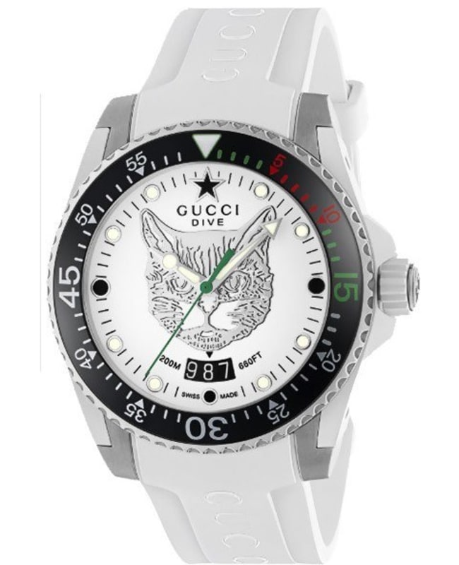 Gucci YA136329 Dive watch features a white dial with a cat graphic, silver-tone stainless steel case, black and green bezel, and a white rubber strap.