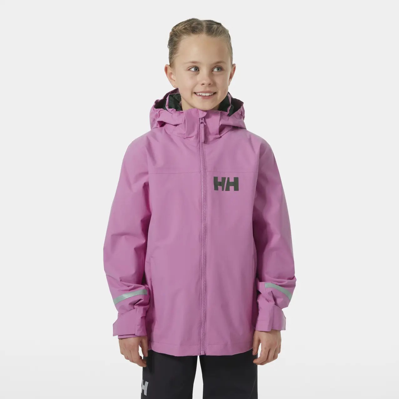 Bright pink waterproof jacket for children by Helly Hansen, featuring a hood, reflective stripes, and the HH logo on the chest and sleeve, made from durable material.