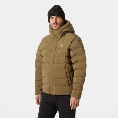 Tan puffer jacket with a hood, featuring a zip front, side pockets, and a logo on the chest, worn by a model in a black beanie against a plain background.