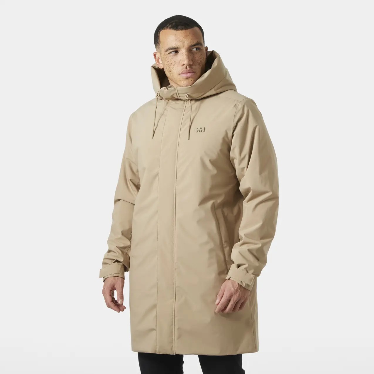 Beige waterproof jacket with a hood, featuring a front zipper, adjustable cuffs, and a minimalistic design, ideal for outdoor activities.