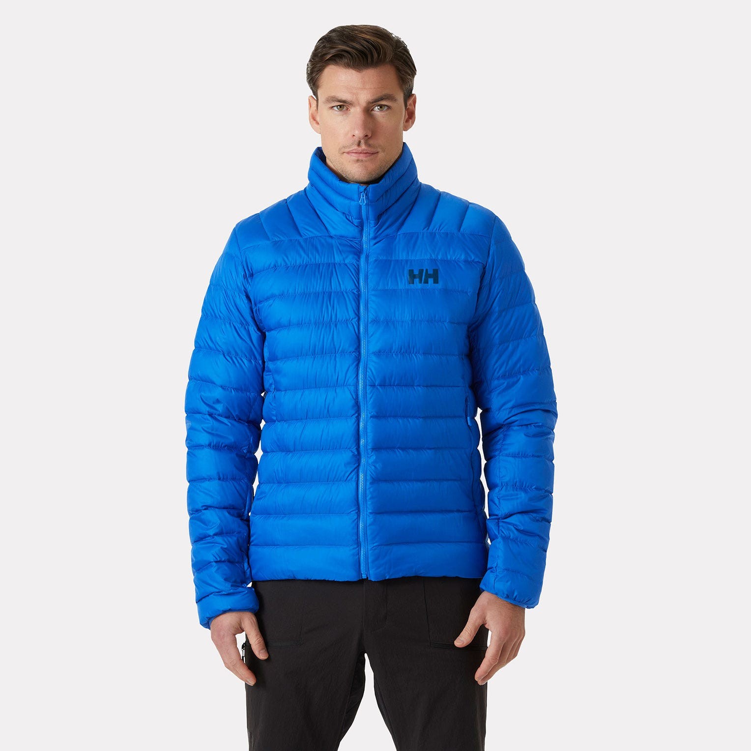 Bright blue sleeveless down jacket featuring a high collar, quilted design, and Helly Hansen logo on the chest, ideal for warmth and outdoor activities.