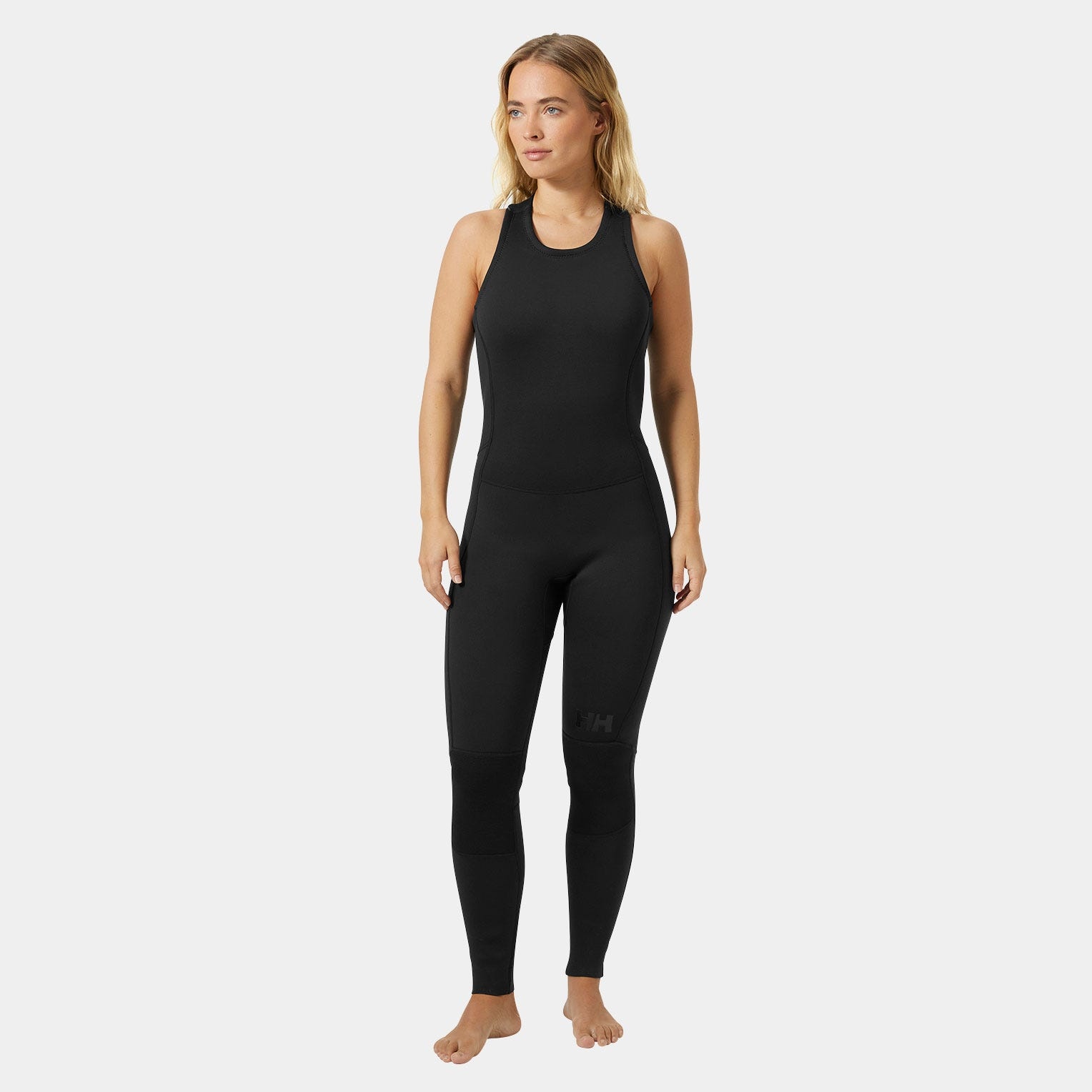 Black women's overalls made of stretchy, water-resistant material, featuring a sleeveless design and Helly Hansen logo on the leg, ideal for water activities.