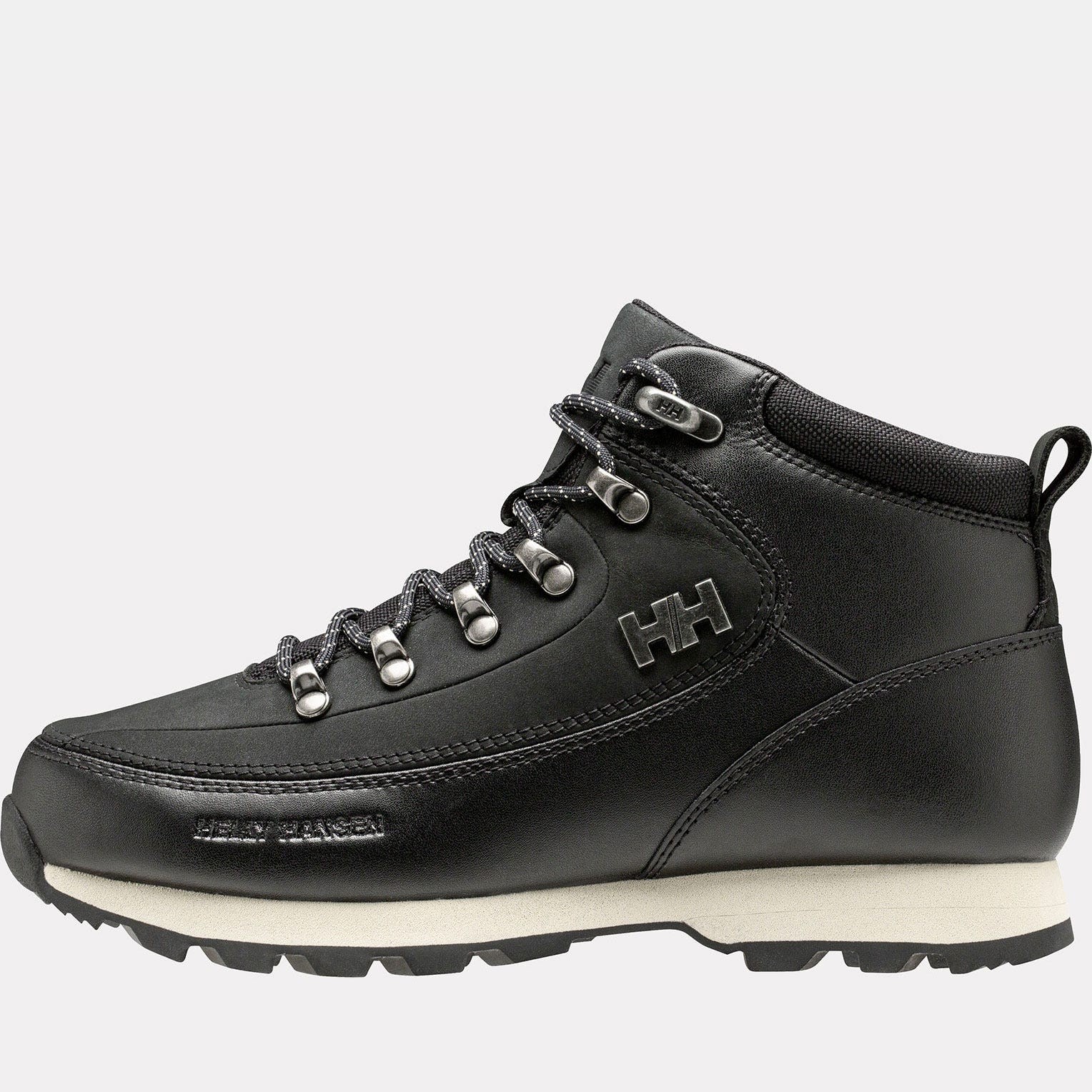 Black leather women's boots by Helly Hansen, featuring silver eyelets, a padded collar, and a rugged white sole, designed for durability and style.