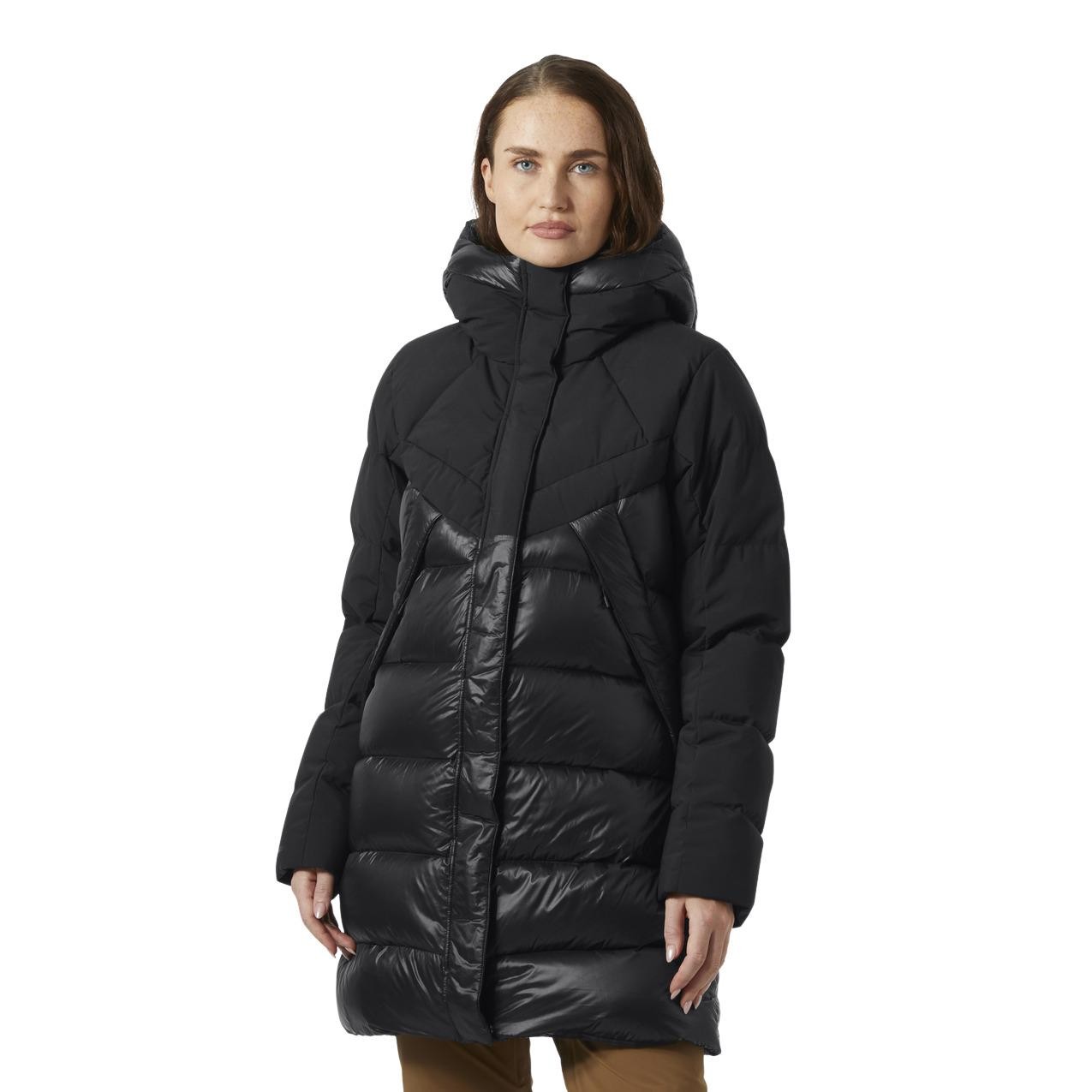 Black women's parka by Helly Hansen featuring a quilted design, high collar, and a sleek, shiny front panel for added style and warmth.
