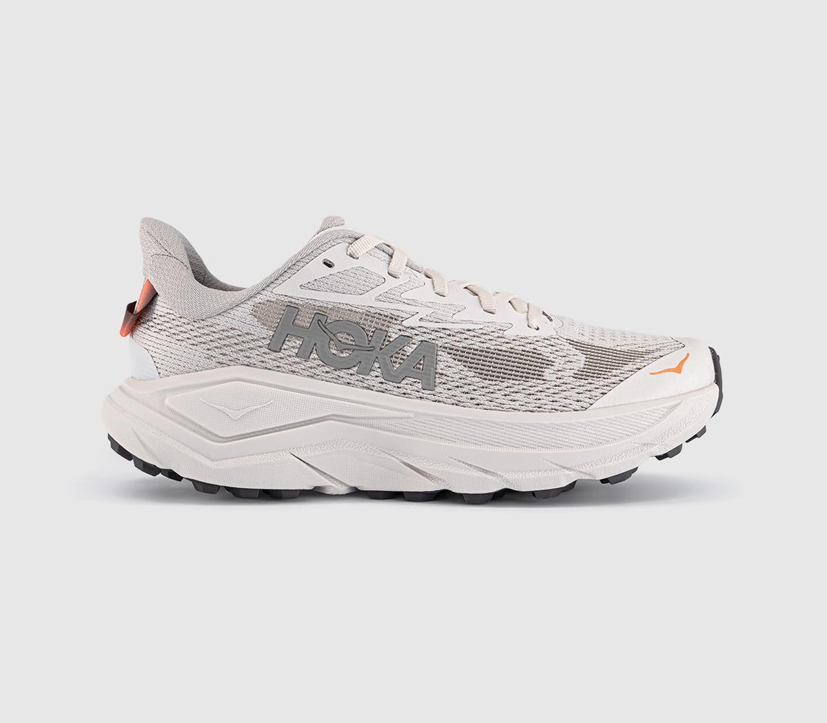 Women's HOKA Challenger 8 shoes in stucco and asphalt grey, featuring a breathable mesh upper, cushioned sole, and prominent HOKA branding on the side.