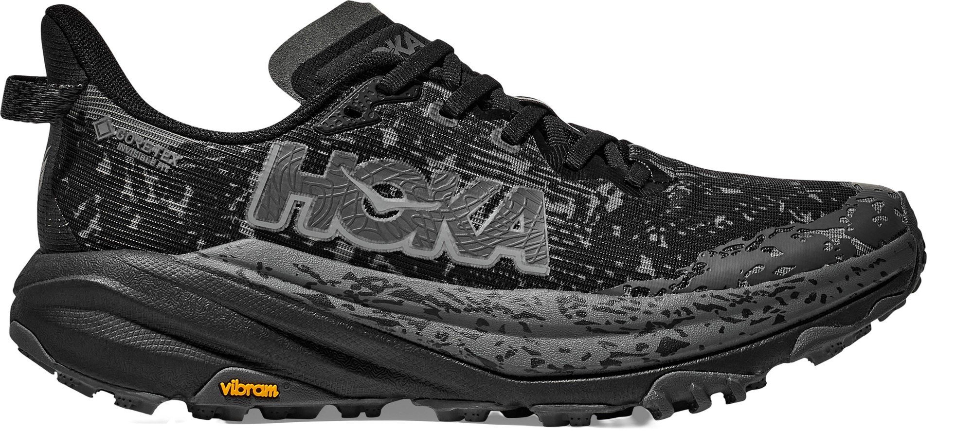 Women's HOKA Speedgoat 6 trail running shoes in black and outer orbit, featuring a textured upper, prominent HOKA logo, and Vibram outsole for enhanced traction.