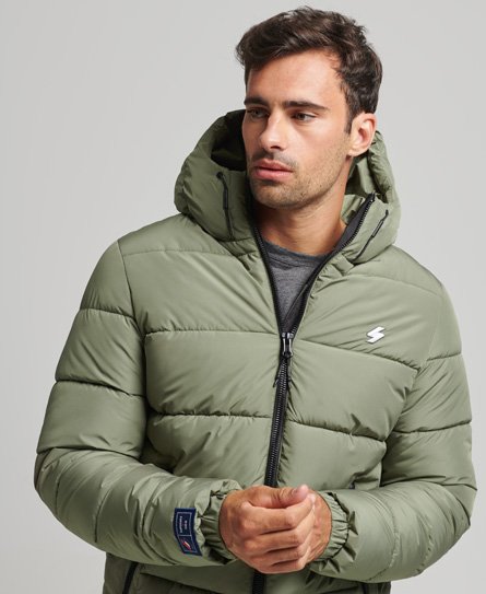 Olive green hooded puffer jacket with a zip front, featuring a logo on the chest, elastic cuffs, and a sleek, sporty design.