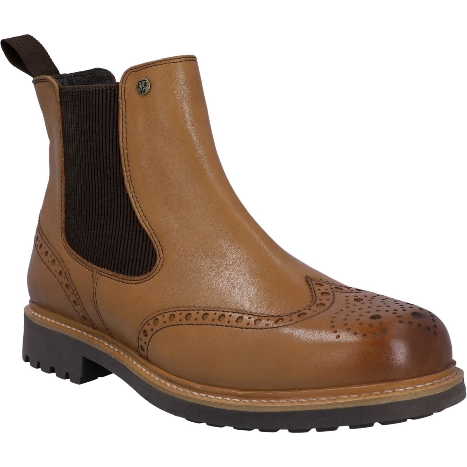 Tan leather Chelsea boot featuring brogue detailing, elastic side panels, a rounded toe, and a rugged sole for enhanced grip.