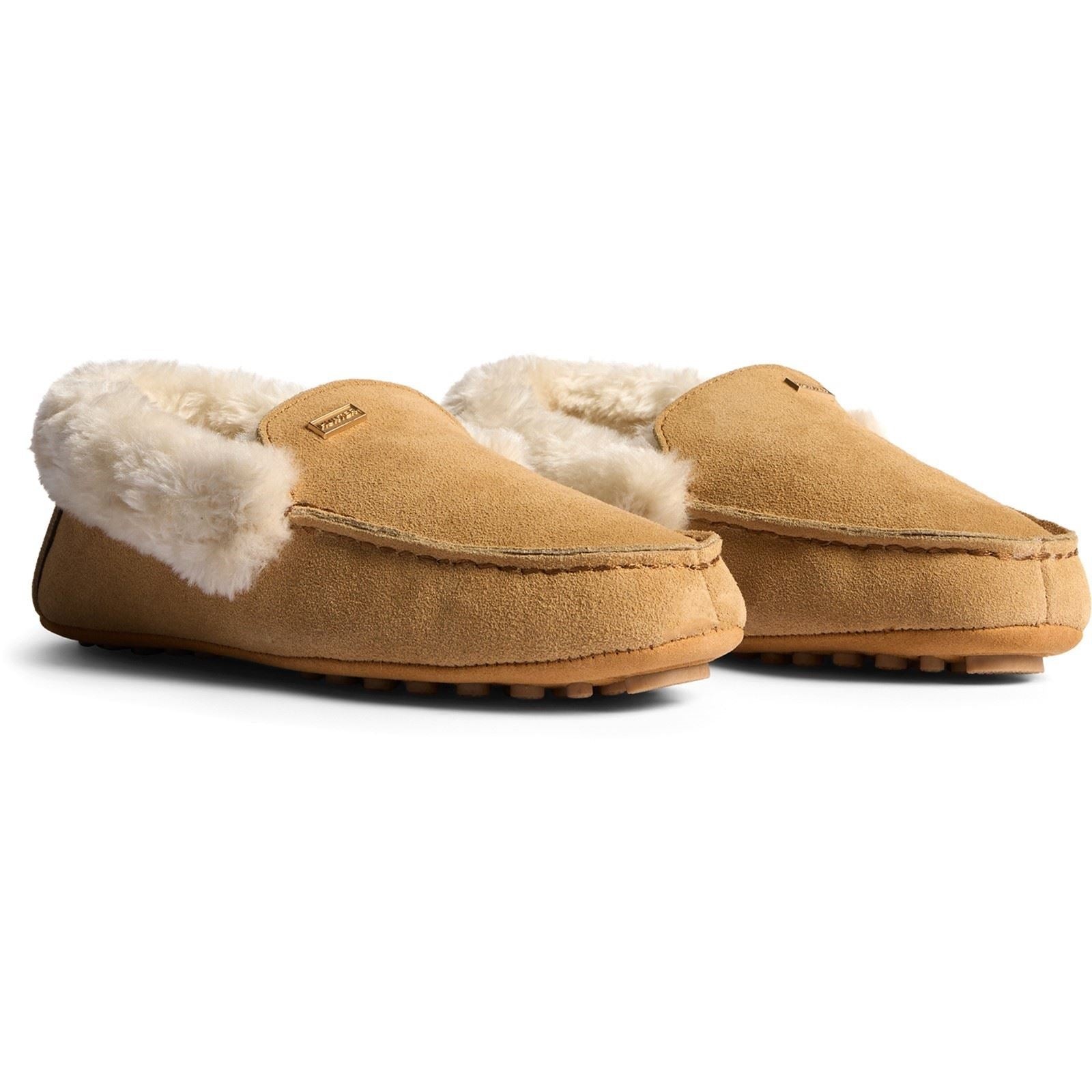 Biscuit-colored suede moccasin slippers with a soft sherpa lining and rubber soles, featuring a classic slip-on design for comfort and warmth.
