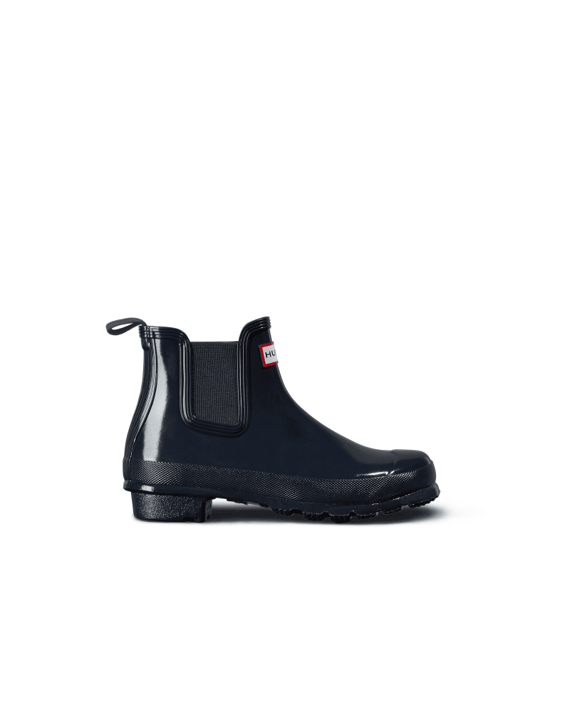 Navy glossy Chelsea boots by Hunter, featuring elastic side panels, a pull tab, and a durable rubber sole, designed for women's casual wear.