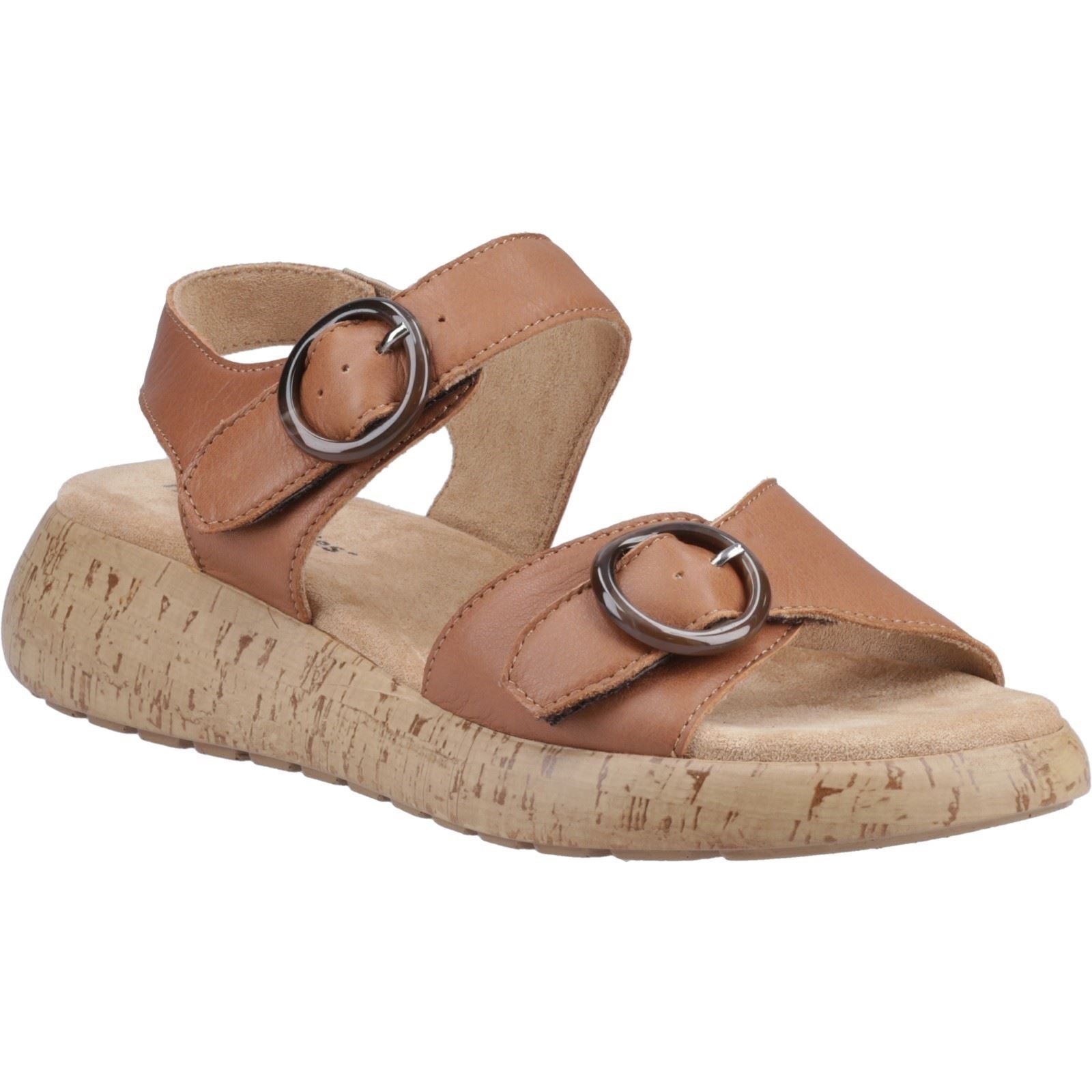Tan leather sandal featuring two adjustable buckle straps, a cushioned footbed, and a textured cork-like sole for comfort and style.