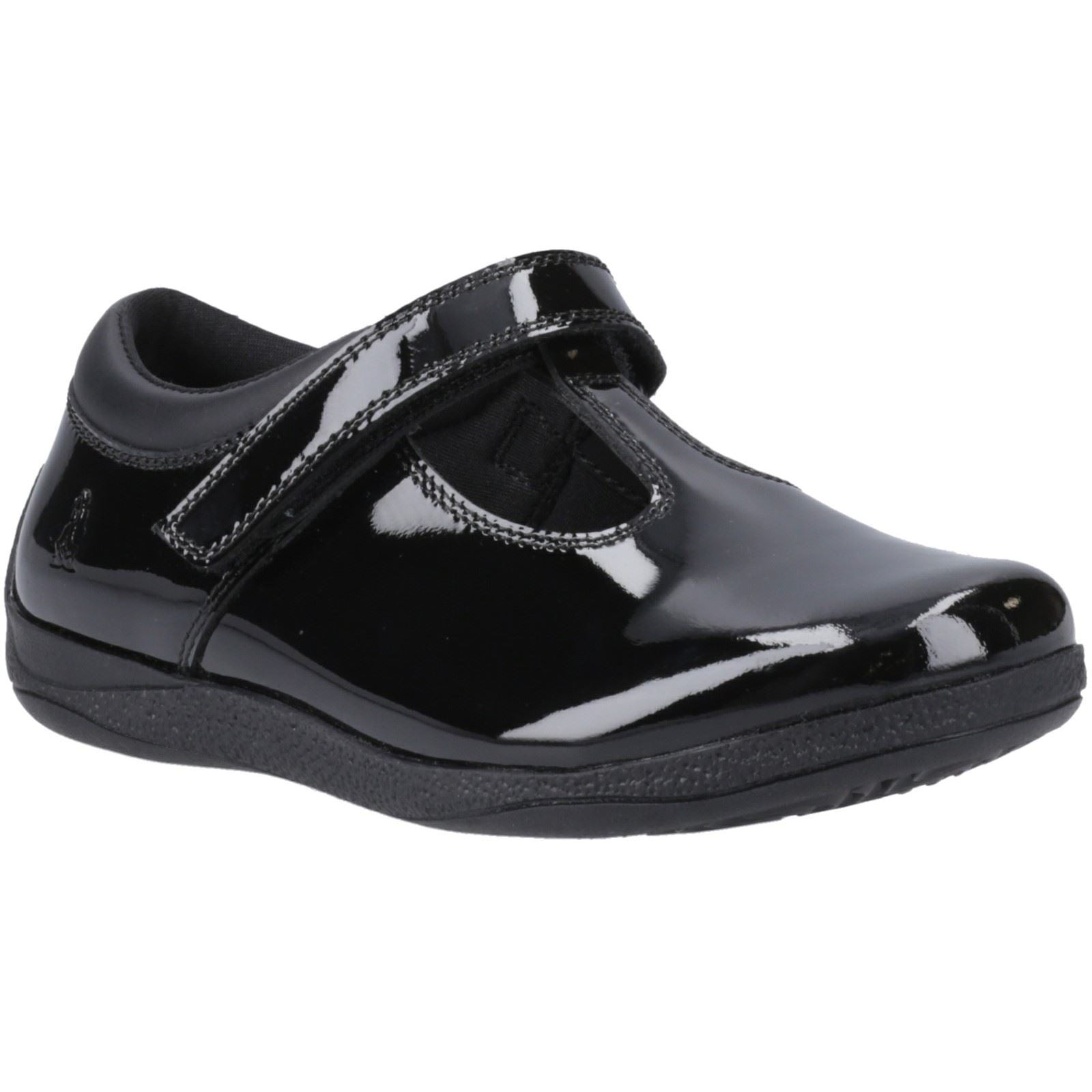 Black T-bar leather youth shoes by Hush Puppies featuring a glossy finish, adjustable strap, and cushioned sole for comfort.