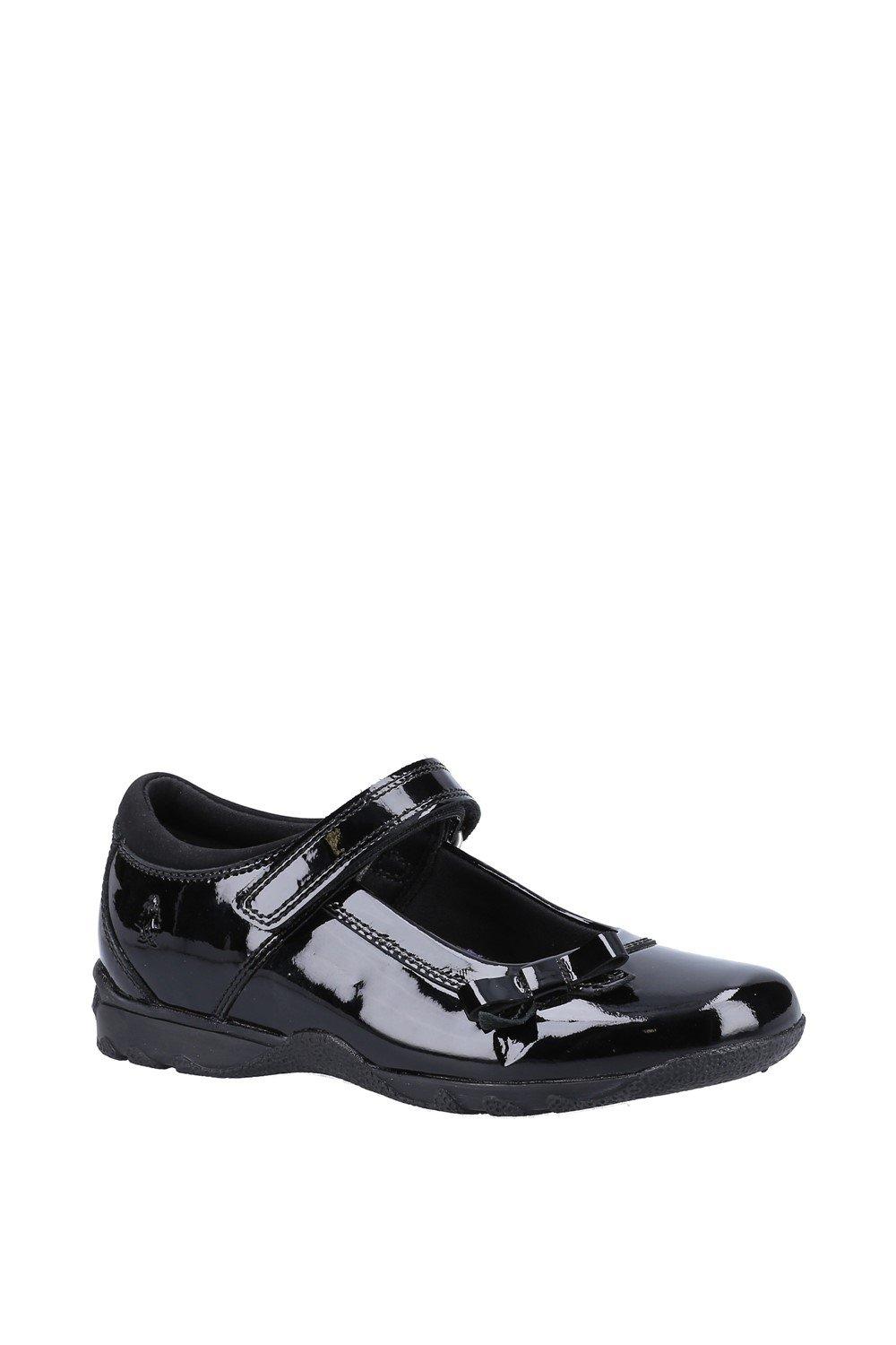 Black leather Mary Jane shoes for girls featuring a shiny patent finish, a Velcro strap, and a cushioned sole for comfort.