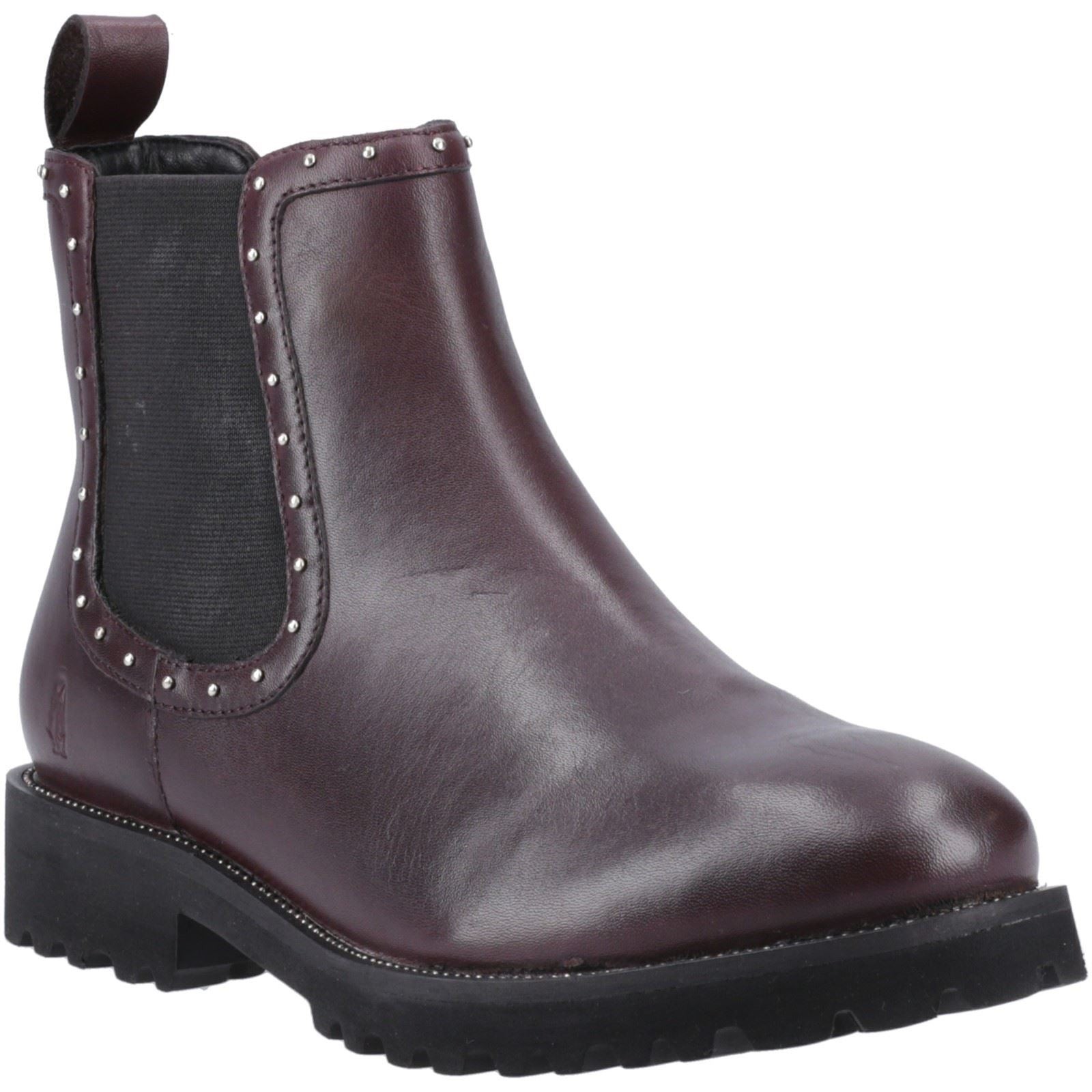 Plum leather flat Chelsea boot featuring elastic side panels, studded detailing around the ankle, and a chunky black sole for added traction.