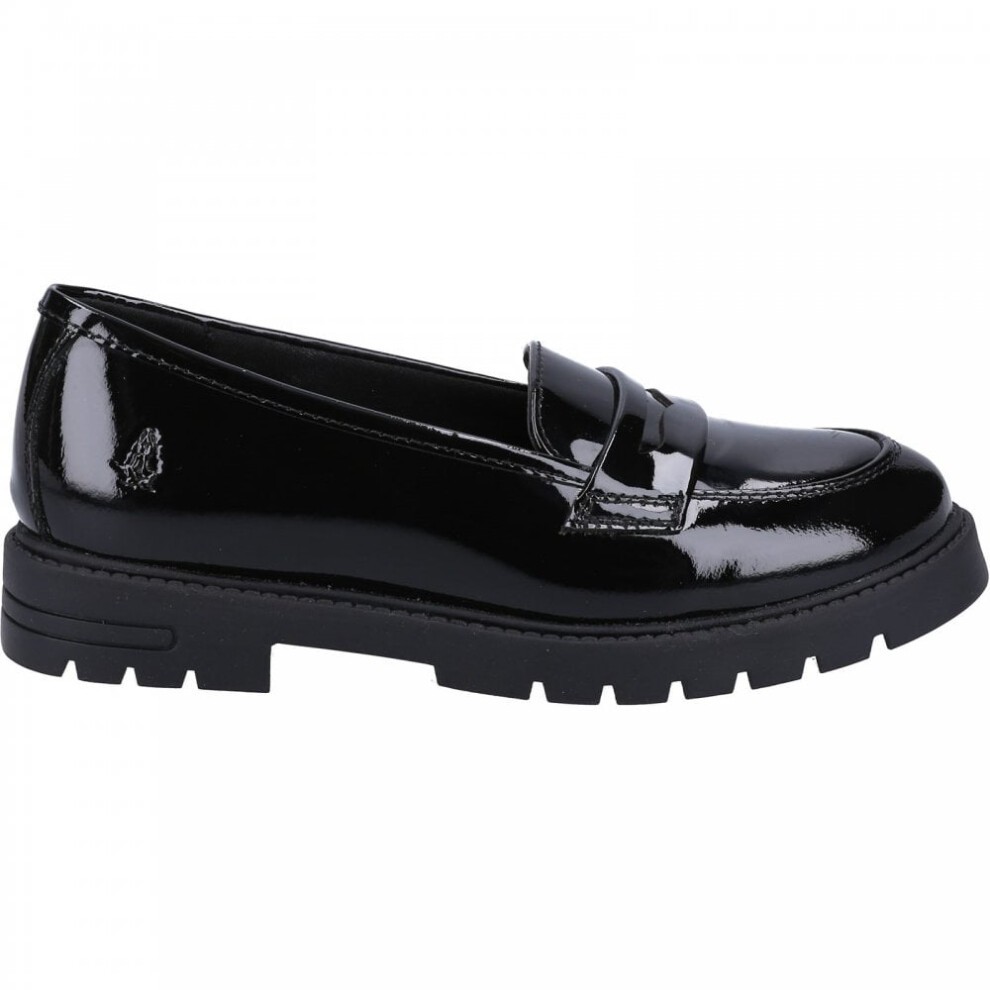 Black patent leather loafers with a sleek design, featuring a classic penny strap and a chunky black sole for added comfort and style.