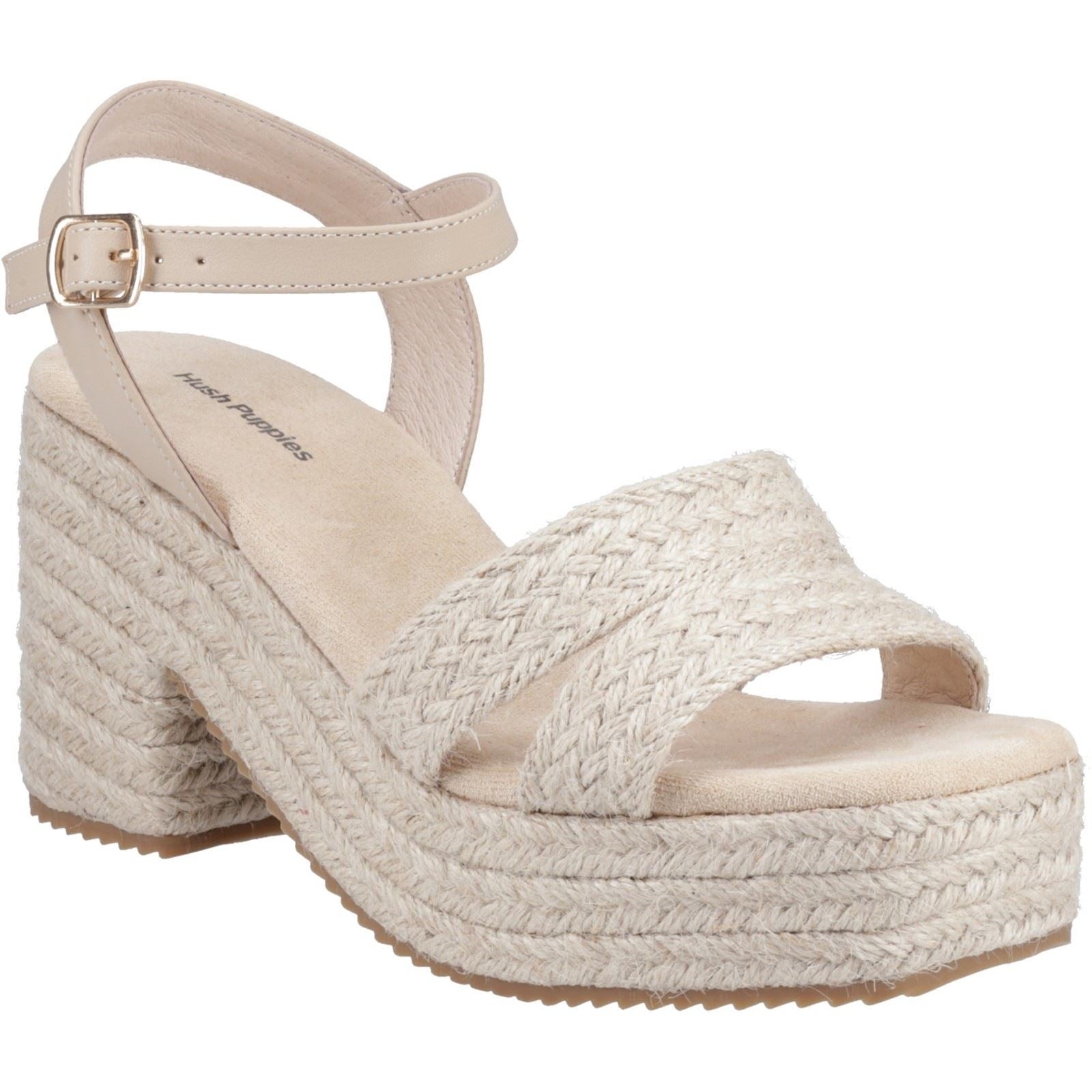 Nude textile espadrille heel sandals featuring a braided jute platform, wide crossover straps, and an adjustable ankle strap for a stylish summer look.