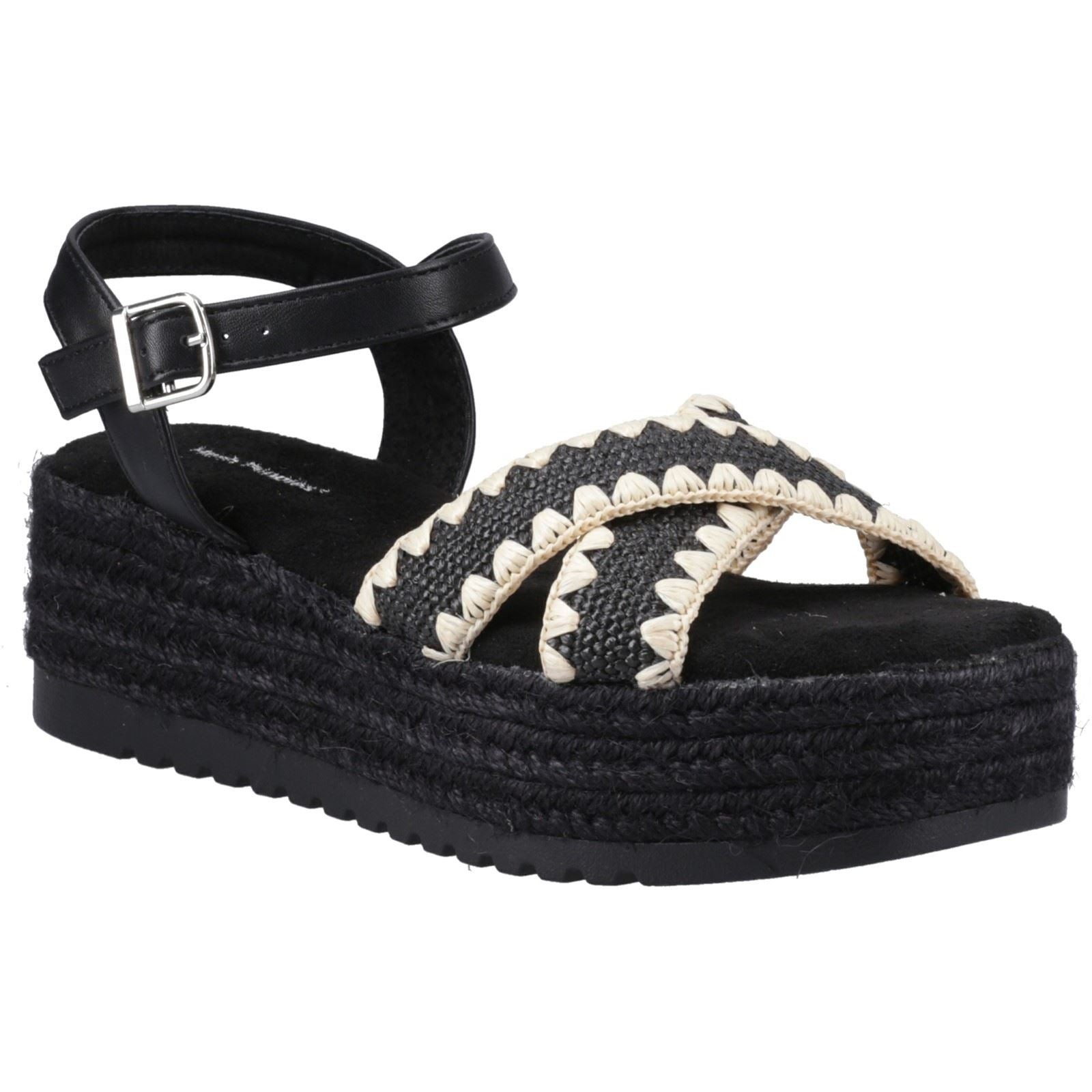 Black espadrille sandals featuring a woven design, adjustable ankle strap, and a textured platform sole with a jute-like appearance.