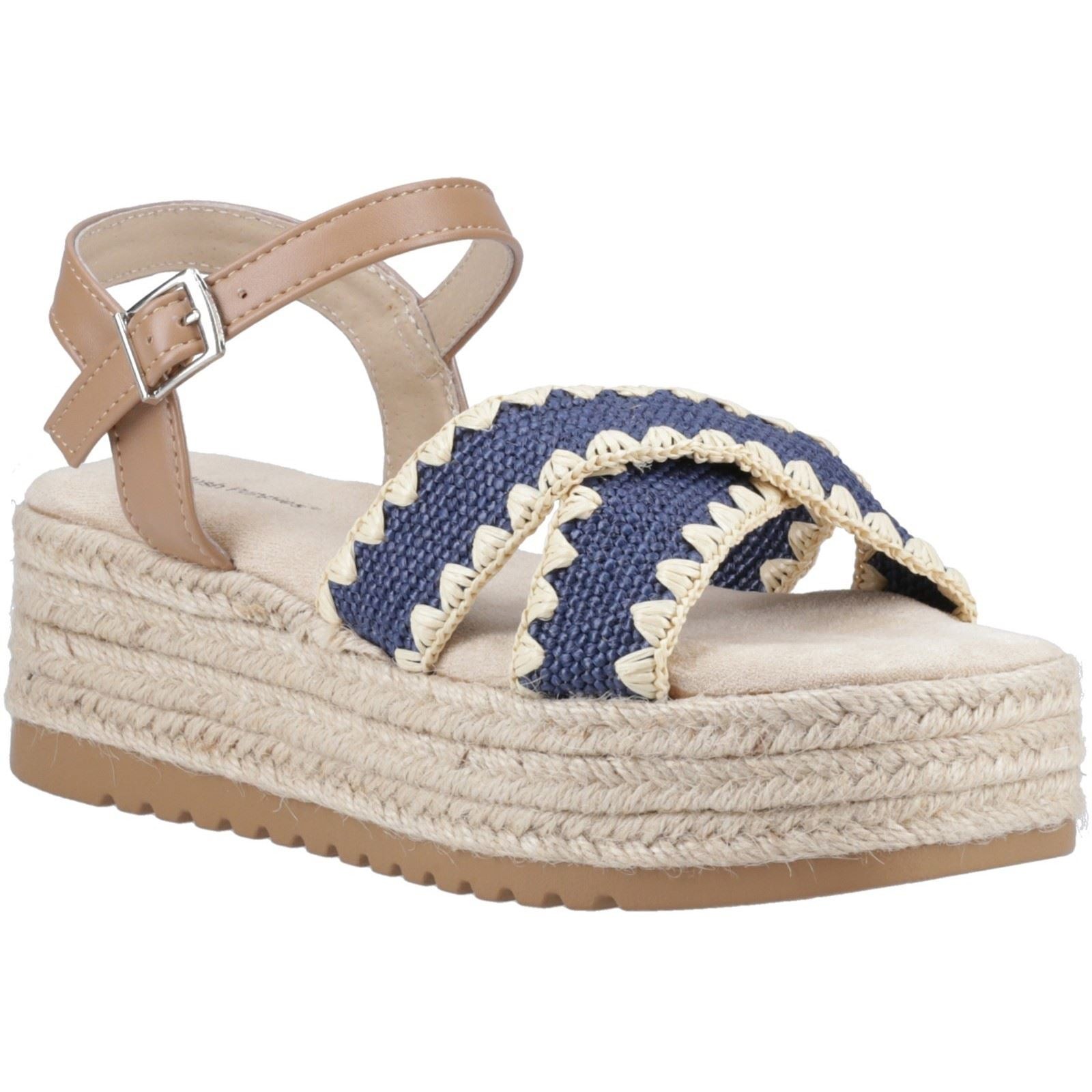 Navy espadrille sandal with braided navy fabric upper, tan ankle strap, and a jute-wrapped wedge sole, featuring a comfortable footbed and stylish cross-strap design.