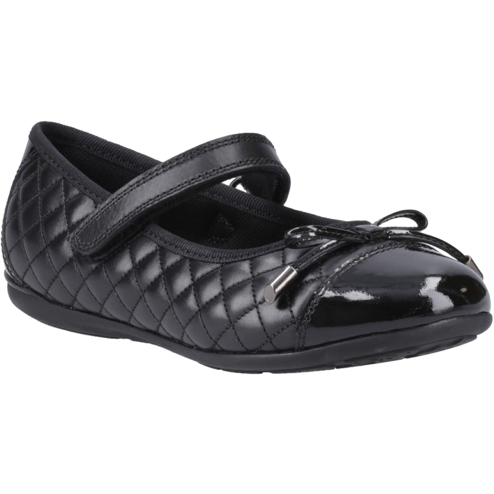 Black quilted ballerina flats with a glossy patent toe, featuring a decorative bow and a secure strap across the instep, designed for junior sizes.