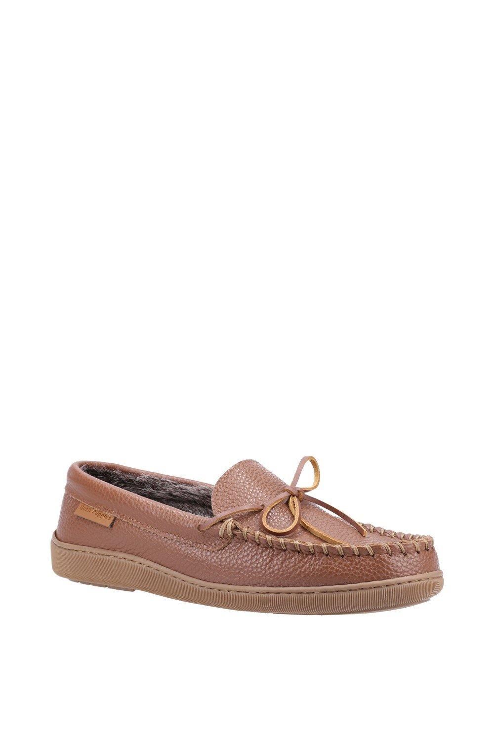 Tan leather slippers with a textured finish, featuring a decorative bow, stitched detailing, and a rubber sole, designed for men in size 6 by Hush Puppies.