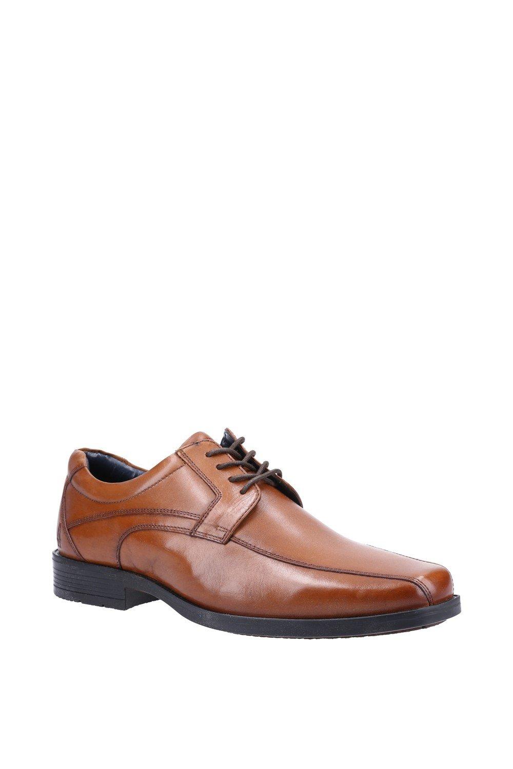 Tan leather lace-up shoes with a sleek design, featuring a rounded toe, subtle stitching details, and a black rubber sole, in size 12 by Hush Puppies.