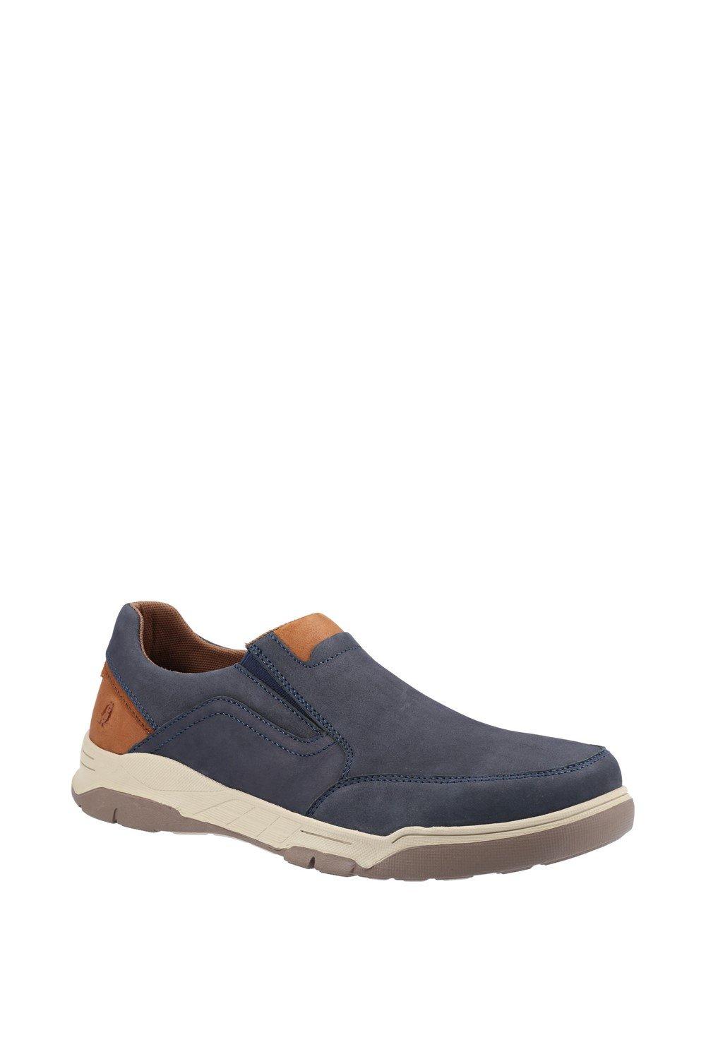 Navy slip-on shoes by Hush Puppies featuring a suede-like upper, tan accent on the heel, and a cushioned sole for comfort, available in size 6.